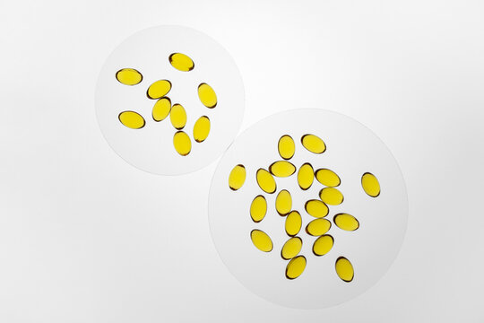 omega-3 and vitamin D colorful capsules on white background