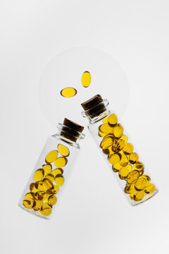 Colorful Omega-3 and Vitamin D capsules in glass bottles