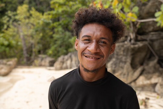 Pacific Islander Man Smiling on Tropical Beach in Raja Ampat