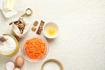 Different ingredients for making carrot cake on beige textured table, flat lay. Space for text