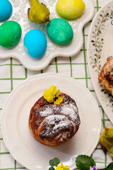 Easter cruffins with chocolate filling on Easter background and painted eggs.