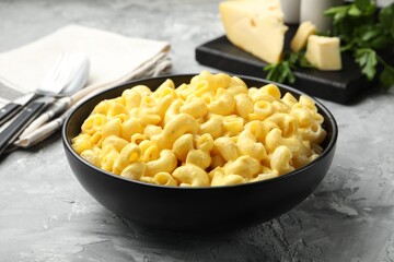 Delicious pasta with cheese sauce served on grey table, closeup