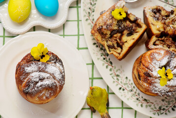Easter cruffins with chocolate filling on Easter background and painted eggs.
