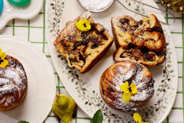 Easter cruffins with chocolate filling on Easter background and painted eggs.