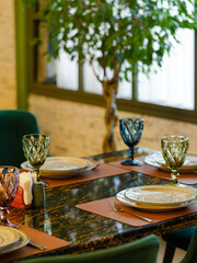 Empty glasses and plates on table in restaurant