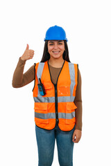 vertical Smiling female engineer making thumbs up gesture wearing safety vest and helmet