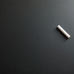 chalkboard with a single piece of white chalk resting on it, emphasizing simplicity and clarity. Ideal for modern design concepts