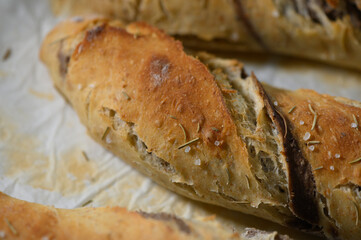 Freshly baked artisan bread with crispy crust and fragrant herbs brings warmth to any kitchen during a cozy afternoon