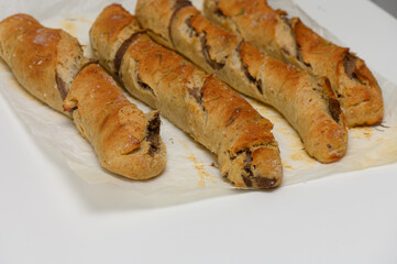 Delicious homemade pastries filled with rich chocolate, perfect for a cozy afternoon snack in a warm kitchen