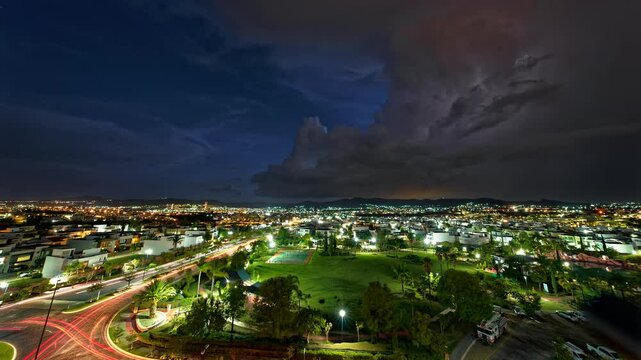 Horizontal landscaped video of Puebla cityscape with purple lightnings during nighttime