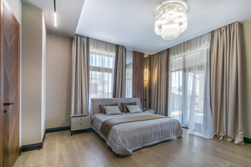 A bedroom with an elegant interior design in pastel colors. Cute details create coziness and comfort.