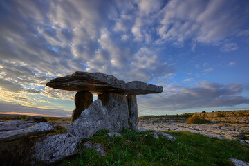 Sunset over Poulnabrone dolmen an ancient portal tomb in the Burren, County Clare, in the west of...