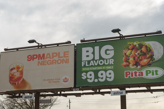 roadside pylon billboard spotted on St Clair Av W in Toronto, Canada (9PMapleNegroni and Pita Pit)