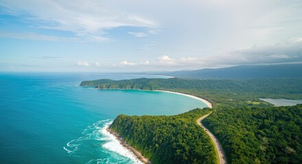 Aerial view of tropical coastline with lush greenery and blue ocean
