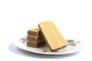 stack of chocolate wafers in a glass plate isolated on white background