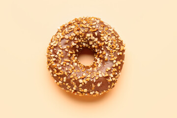 Sweet chocolate donut on beige background