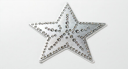 Obraz premium Intricately designed star-shaped patch densely covered in clear, glittering rhinestones, ready for iron-on application as a fashion accessory.
