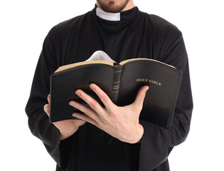 Young priest reading Holy Bible on white background, closeup