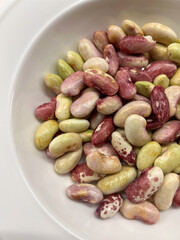 A beautiful variety of colorful, dried beans beautifully displayed in a bowl for cooking