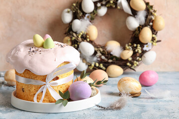 Composition with delicious decorated Easter cake and painted eggs in plate on color background