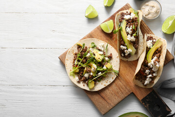 Tray with delicious fresh tacos on white wooden background