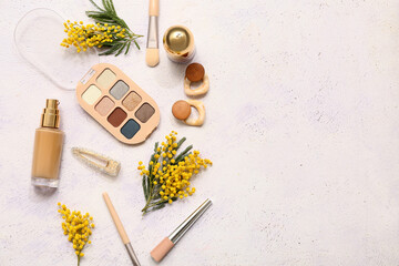 Decorative cosmetics with hair clasp-pin, stylish earrings and mimosa flowers on white background