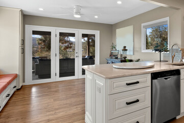 A kitchen with white cabinets and sleek stainless steel appliances