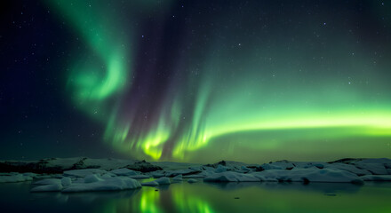 Vibrant green aurora borealis dances above a stark, icy landscape in Iceland, reflecting in the dark waters below.