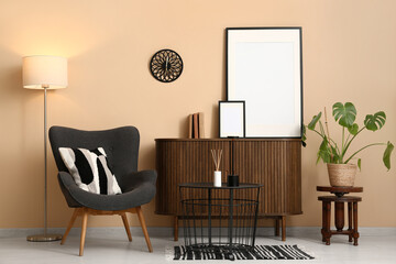 Armchair with wooden commode, glowing lamp and black table in living room
