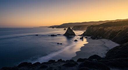 Coastal Landscape At Sunset Featuring Dramatic Cliffs And Rock Formations