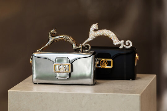 Milan, Italy - 02.08.2023: Luxury designer Lanvin handbags with elegant gold and silver panther handles in fashionable display.
