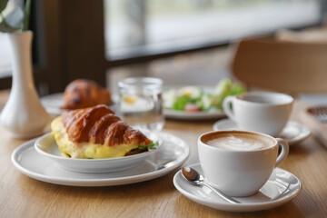 Delicious breakfast served on wooden table in cafe
