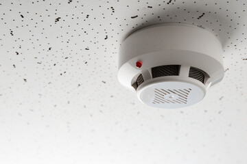 Smoke detector on light textured background, space for text. Alarm system