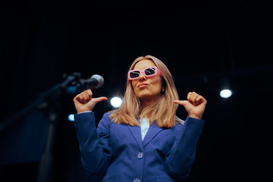 Arrogant Woman with Sunglasses Public Speaking on Stage. Vain self confident motivational speaker wearing shades at her show
