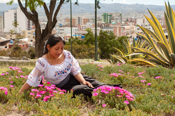 A Woman Sitting Comfortably Among Colorful Flowers in a Beautiful Urban Landscape Setting