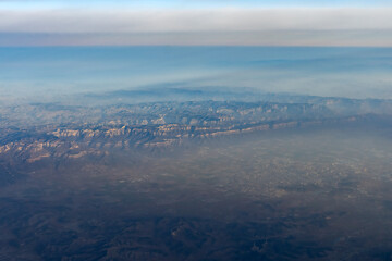 Breathtaking Aerial View of Mountain Ranges and Sky