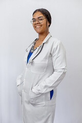 Medical concept of beautiful Brazilian female doctor in white coat with stethoscope, waist up....