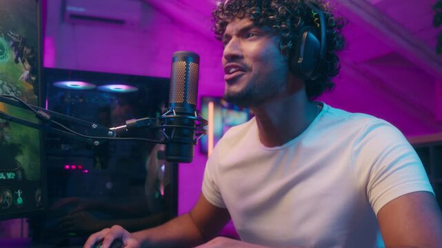 Indian Arabian Latina man talking shouting microphone influencer male excited guy gamer streamer radio host presenter emotional blogger vlogger online stream gaming playing video game addict in studio
