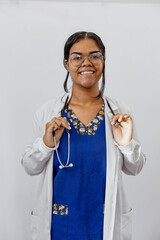 Medical concept of beautiful Brazilian female doctor in white coat with stethoscope, waist up....