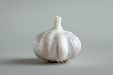 A whole garlic bulb with a smooth white and purple surface