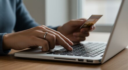 Woman using credit card for online shopping on laptop, making secure payment transaction, entering card details and enjoying modern technology convenience
