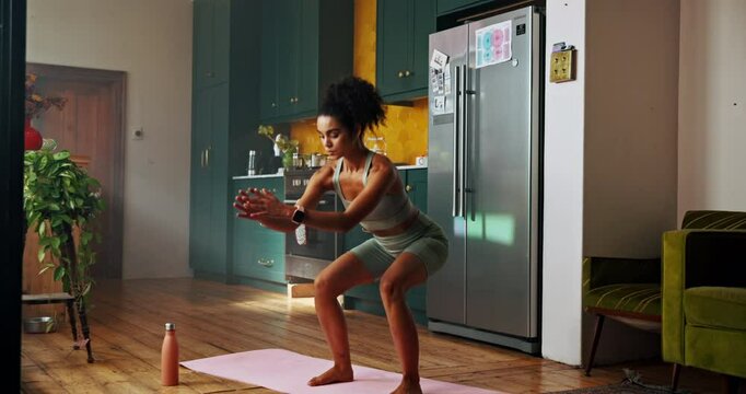Woman, exercise and squat with fitness, home or balance with growth for leg muscle in kitchen. Girl, workout and training with challenge, stretching and development for glutes in morning at apartment