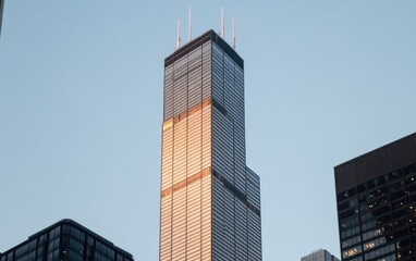 Obraz premium Modern Skyscraper at Sunset, Golden Light