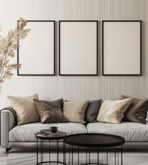 Three blank frames above sofa with pillows and coffee tables.
