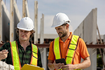 Two male Caucasian engineers are having conversation on quality inspection using a check list in a...