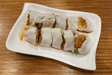 close up of a Cantonese Dim Sum dish consisting of deep fried crispy dough stick wrapped inside silky rice noodles called Zhaliang or Jaleung