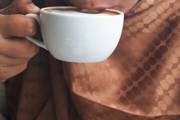 Enjoying a warm cup of coffee in a cozy setting