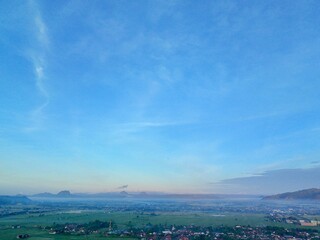 Aerial photography of rural settlement rice field scenery, sunrise in the morning with beautiful dew mist