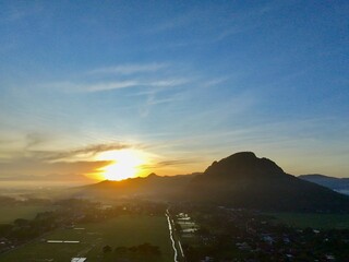Aerial photography of rural settlement rice field scenery, sunrise in the morning with beautiful...