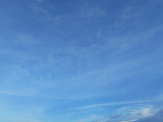 Beautiful blue sky with white clouds. The sky was clear and bright, and clouds were scattered all...